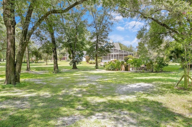 view of yard with a lanai