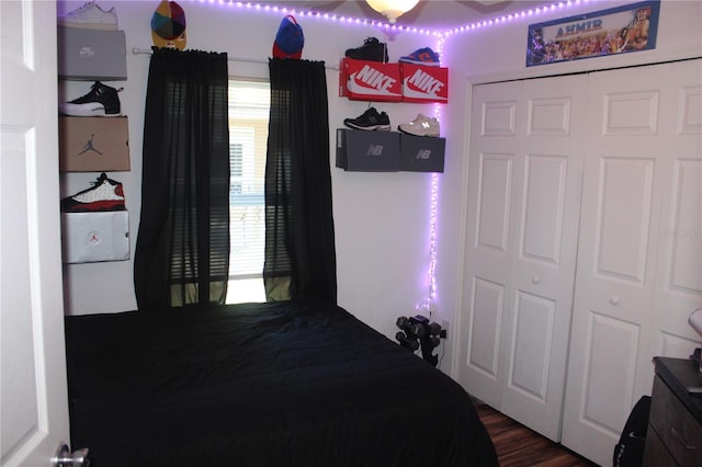 bedroom with a closet and dark hardwood / wood-style floors