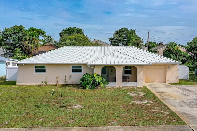 single story home featuring a garage, a porch, and a front lawn