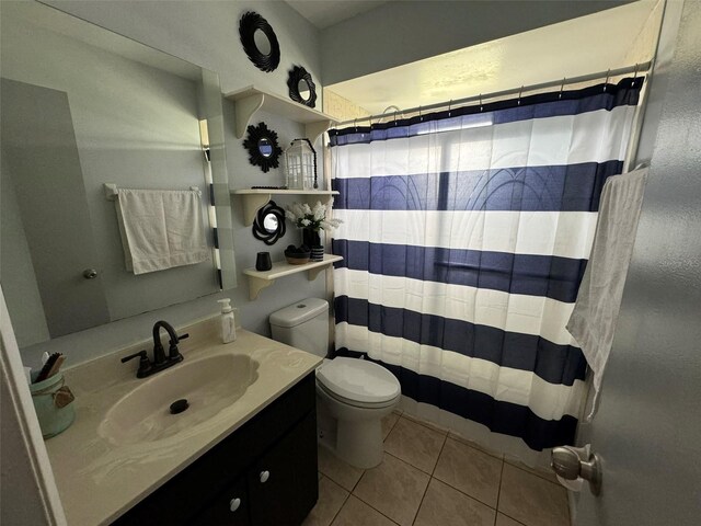full bath with tile patterned flooring, a shower with curtain, toilet, and vanity