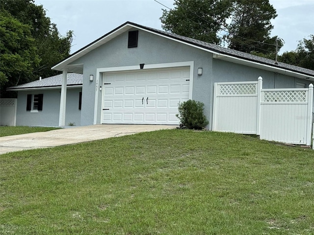 garage featuring driveway and fence