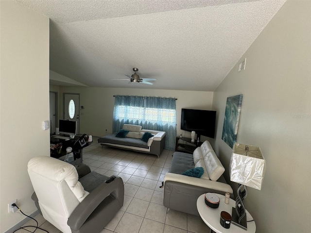 living area with visible vents, a ceiling fan, a textured ceiling, light tile patterned floors, and lofted ceiling