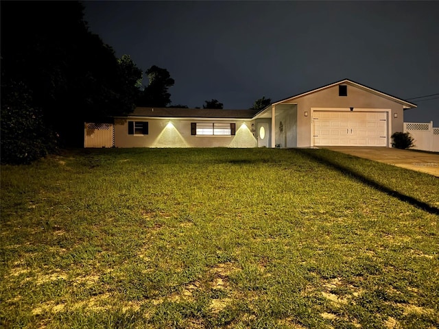 single story home with fence, stucco siding, a lawn, driveway, and an attached garage