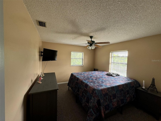 bedroom with visible vents, a textured ceiling, carpet, and a ceiling fan