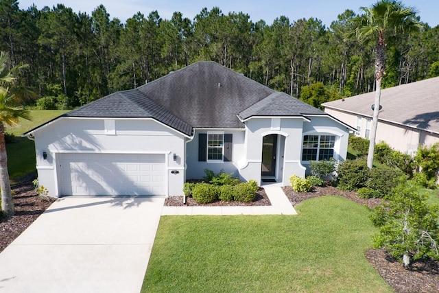 view of front of house with a garage and a front yard