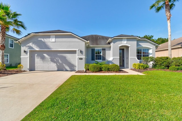 ranch-style home featuring a garage and a front lawn