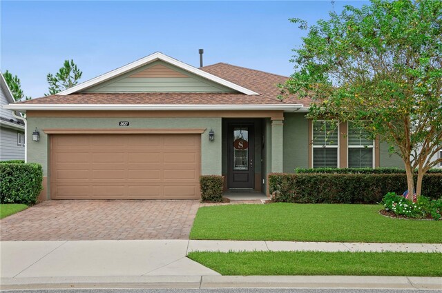 ranch-style home featuring a garage and a front lawn