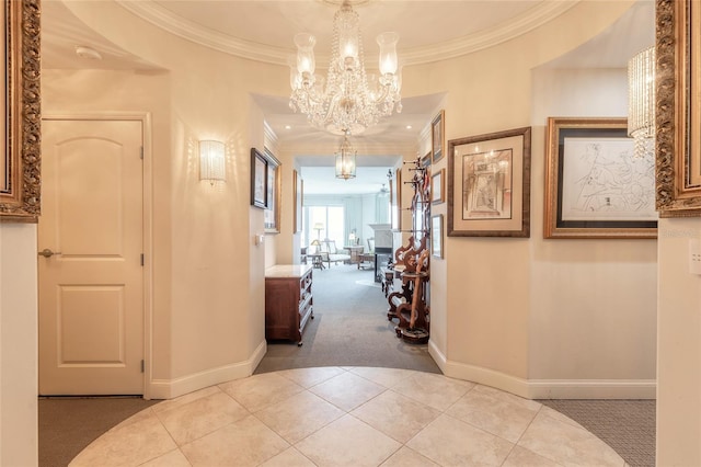 corridor with ornamental molding, light carpet, and a notable chandelier