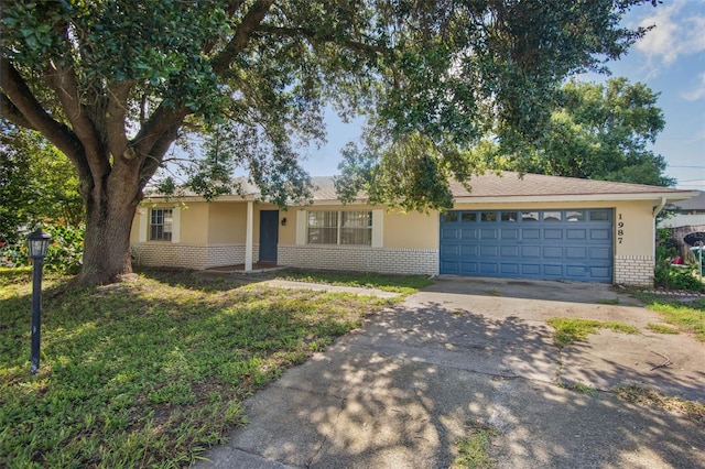 single story home with a garage and a front lawn