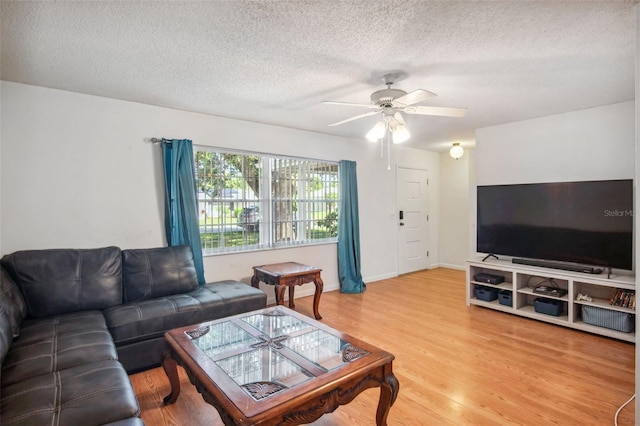 living room featuring a textured ceiling, ceiling fan, and hardwood / wood-style floors