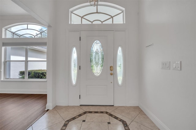 foyer entrance featuring a wealth of natural light and light tile patterned floors