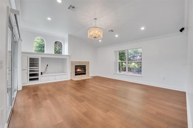 unfurnished living room featuring light hardwood / wood-style flooring, plenty of natural light, and vaulted ceiling