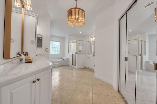 bathroom featuring vanity, a notable chandelier, tile patterned floors, and plus walk in shower