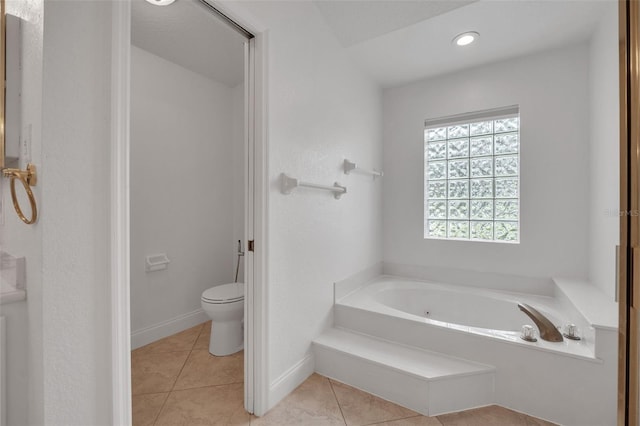 bathroom with a bath, tile patterned flooring, and toilet