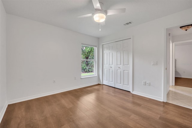 unfurnished bedroom with a closet, ceiling fan, and light hardwood / wood-style floors