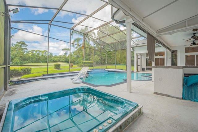 view of swimming pool with glass enclosure, ceiling fan, and a patio area