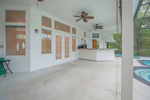 view of patio / terrace with french doors, glass enclosure, and ceiling fan