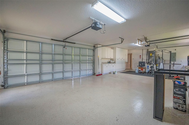 garage with a garage door opener and electric panel