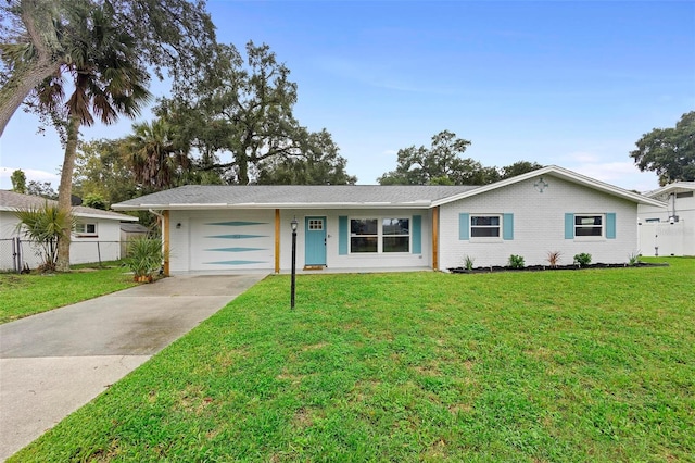 ranch-style house featuring a garage and a front yard