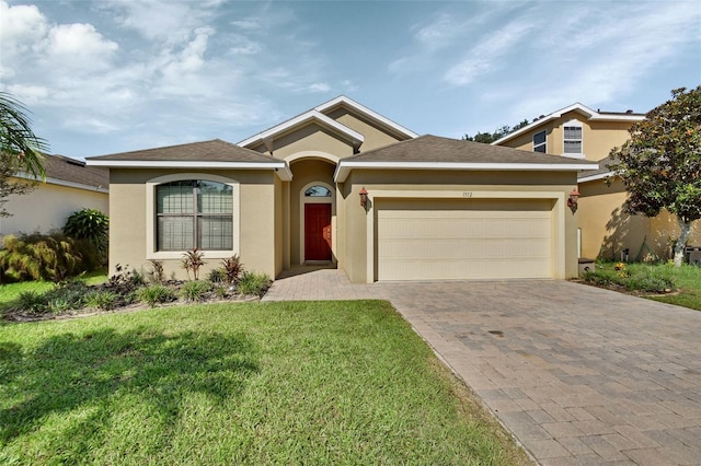 view of front of house with a front yard and a garage