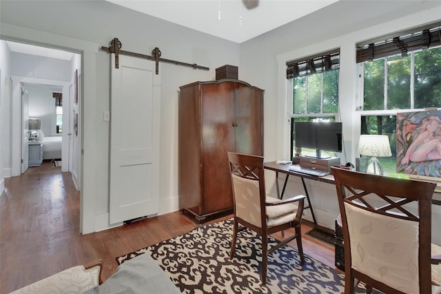 office area featuring a barn door and hardwood / wood-style floors