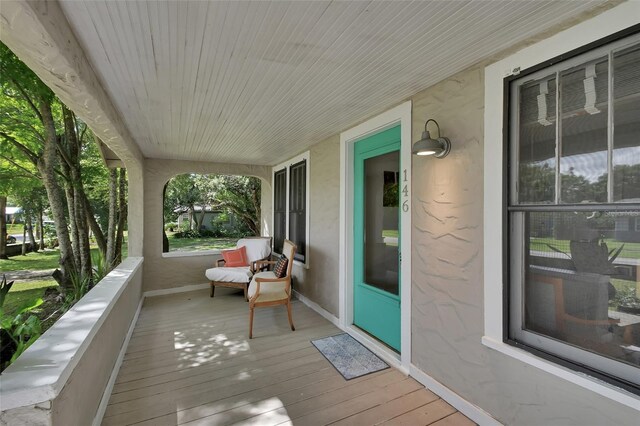 wooden terrace featuring covered porch