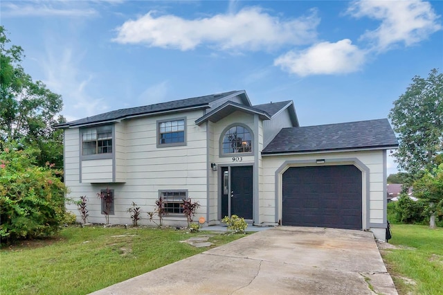 view of front of home featuring a front yard and a garage