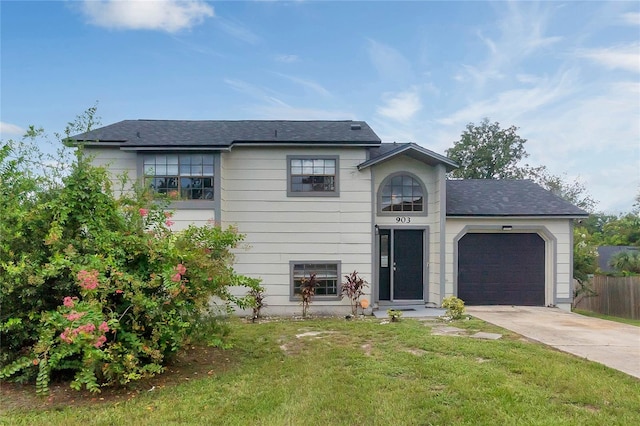 view of front of house with a garage and a front lawn