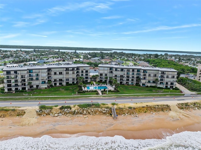 birds eye view of property featuring a water view and a view of the beach