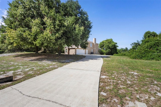 view of front of property featuring a garage and a front yard