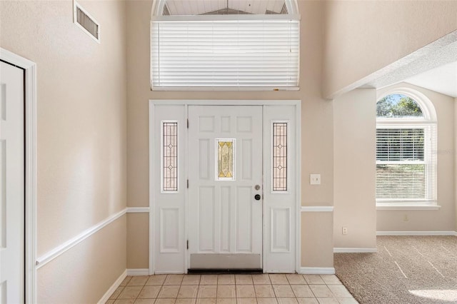 tiled entryway featuring vaulted ceiling