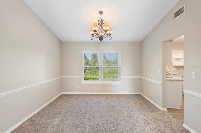 unfurnished room featuring a notable chandelier, sink, and carpet floors