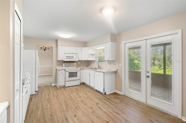 kitchen with french doors, light hardwood / wood-style flooring, white appliances, white cabinetry, and sink