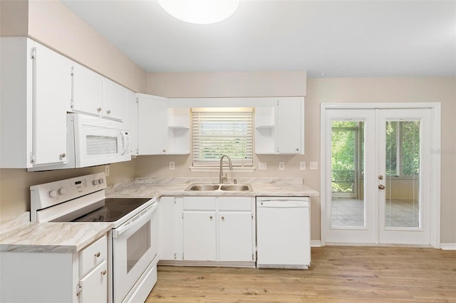 kitchen featuring white appliances, light hardwood / wood-style flooring, sink, and white cabinets