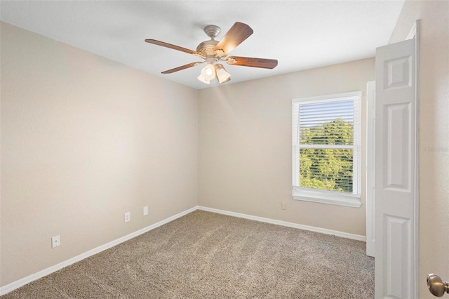 carpeted empty room featuring ceiling fan