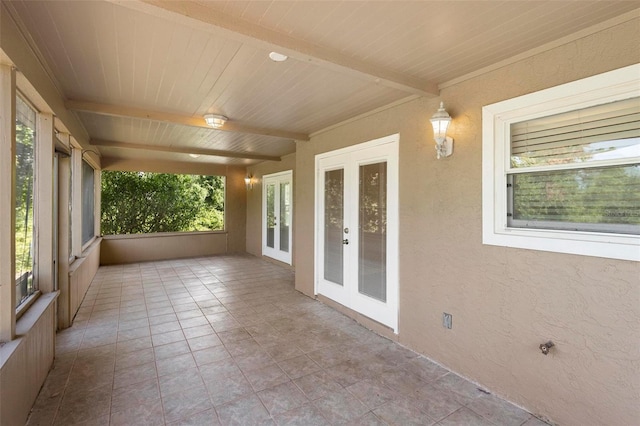 unfurnished sunroom with wooden ceiling, french doors, and beamed ceiling