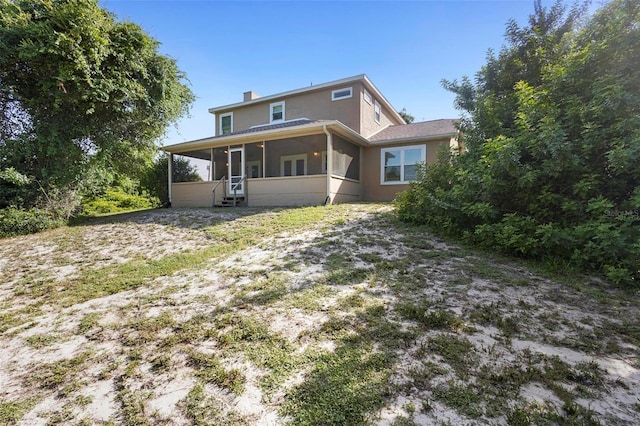 back of house featuring a sunroom