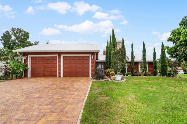 view of front of property with a garage and a front lawn