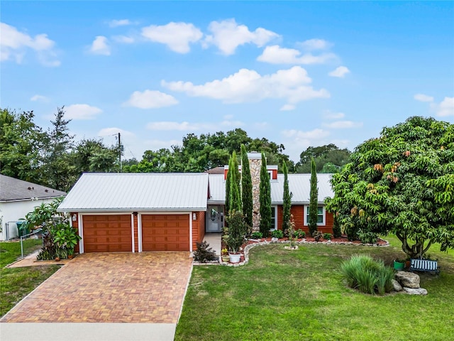 view of front of house with a front yard and a garage