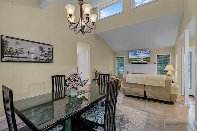 tiled dining area with a fireplace, a high ceiling, and a notable chandelier