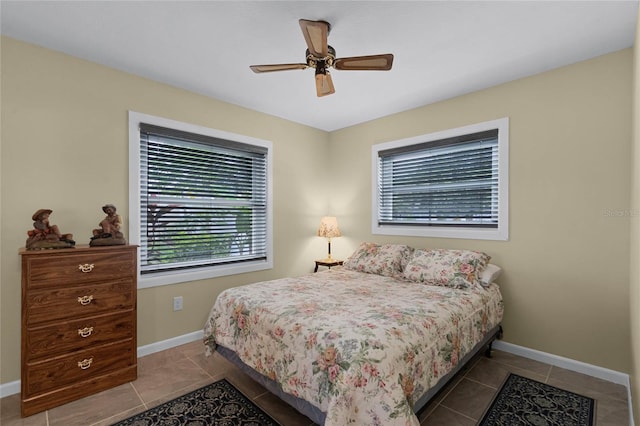 tiled bedroom featuring ceiling fan