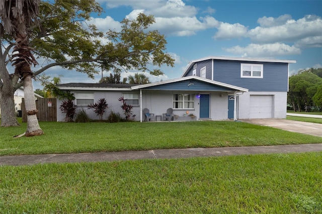 view of front of home featuring a garage and a front lawn