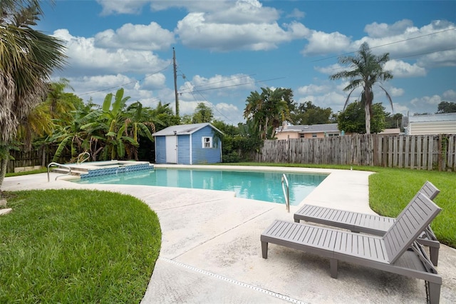 view of pool featuring a storage shed, a yard, and a patio