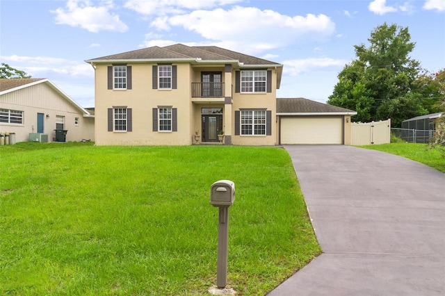 view of front of home with a balcony, cooling unit, a front yard, and a garage