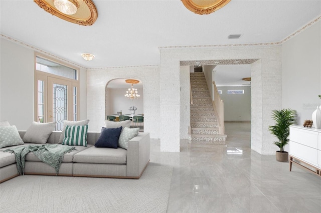 living room featuring ornamental molding and a chandelier