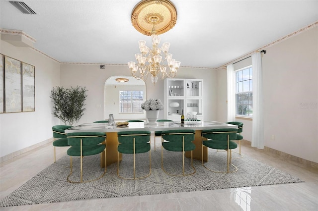 dining area featuring a chandelier and plenty of natural light