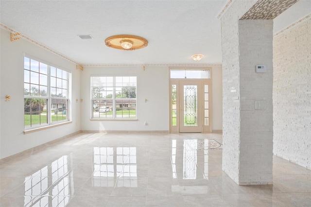 interior space with a textured ceiling and a wealth of natural light