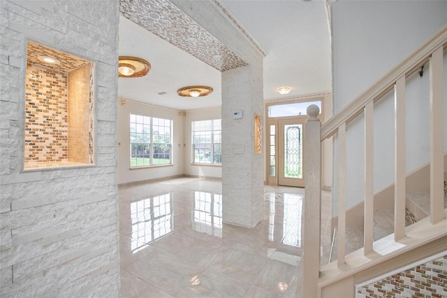 tiled foyer entrance featuring a textured ceiling