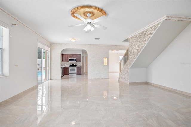 unfurnished living room with ceiling fan