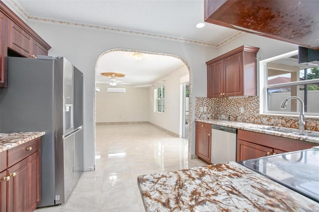 kitchen with ornamental molding, backsplash, appliances with stainless steel finishes, and sink